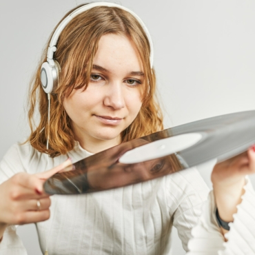 Listening to music from vinyl record. Playing music. Retro music. Vintage style. Analog sound